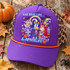 Halloween DTF transfer featuring cartoon dog characters dressed as Jack Skellington and Sally with ghost and witch puppies, moon, bats, pumpkins and tombstones, reading For Real Life and Afterlife Shown on a purple front panel / orange rope / leopard mesh back trucker hat.
