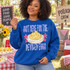 Just Here For The Deviled Eggs DTF Transfer | Funny Potluck & Cookout Design, humorous deviled eggs design printed on a blue sweatshirt worn by a woman at a potluck picnic with deviled eggs and cookout decorations.