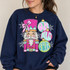 Oh What Fun Nutcracker DTF Transfer | Pink & Mint Christmas Design, colorful pink and mint nutcracker and ornament graphic with snowflakes displayed on a navy sweatshirt