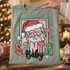 Santa Baby DTF transfer with retro cloud-bearded Santa face in a scalloped green and pink frame, bubble-lettered SANTA, black script Baby text, and scattered stars Shown on a Sage t-shirt.