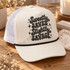 Sweetly Saved. Slightly Savage. retro bubble letter DTF transfer in black halftone texture with sparkly star accents on a pink shirt Shown on a cream foam front panel with black rope and white mesh back trucker hat.