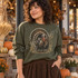 Vintage Wild Turkey DTF Transfer | Watercolor Thanksgiving Fall Design, vintage watercolor wild turkey and autumn foliage design displayed on an olive green sweatshirt in a cozy fall setting with pumpkins