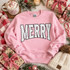 Merry Polka Dot DTF Transfer | Varsity Letters Christmas Design, white varsity-style “MERRY” lettering with black polka dots displayed on a pink sweatshirt in a festive Christmas setting.