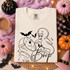 Casper-style ghost nose-booping a hockey-mask-wearing slasher character with Boop script and bats, outline Halloween DTF transfer on cream shirt