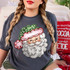 Hand-painted Santa face DTF transfer with round glasses, white beard, and green polka-dot scalloped hat on a gray shirt