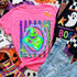 Green bug king villain portrait in a leopard and rainbow striped scalloped frame DTF transfer on a pink shirt