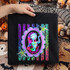 Stitched rag doll girl character in a leopard and rainbow striped scalloped frame DTF transfer on a black shirt