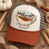 All About the Gravy Baby DTF Transfer | Hand-Painted Thanksgiving Design, colorful hand-painted gravy boat and “All About the Gravy Baby” lettering displayed on a trucker hat among rustic Thanksgiving décor.