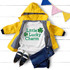 Little Lucky Charm PLAID INFANT Screen Print Transfer, baby outfit with a white t-shirt and a yellow jacket, displayed on a white wooden background with colorful bunting.