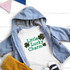Little Lucky Charm LEOPARD INFANT Screen Print Transfer, a graphic design featuring the phrase 'Little Lucky Charm' with leopard print shamrock icons on a white infant T-shirt.