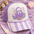 Pastel Ghostface Killer DTF Transfer | Spooky Cute Horror Movie Halloween Design, pastel purple Ghostface illustration with hearts, flowers, and a retro phone displayed on a purple-and-white striped trucker cap