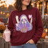 Pastel Ghostface Killer DTF Transfer | Spooky Cute Horror Movie Halloween Design, pastel Ghostface character graphic with flowers, a retro phone, knife, and hearts displayed on a burgundy sweatshirt