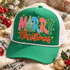 Merry Christmas DTF transfer with colorful patterned block letters, a Christmas tree replacing the E, gold star accents, scattered snowflakes, and red glitter-style script Christmas lettering Shown on a kelly green front panel, white mesh back, white rope trucker hat.