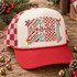 MIMI Christmas DTF transfer in block letters with candy cane stripes, holly berry, red checker, and leopard print patterns, accented with holly leaves, a jingle bell, and a candy cane, with mimi in red cursive script layered across the center Shown on a ivory front panel with red bill and red-and-white checkered mesh trucker hat.