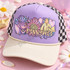 Pennywise Pastel Floral DTF Transfer | Creepy Cute Horror Halloween Design, pastel floral Pennywise horror artwork displayed on a lavender trucker cap with a cream brim and black-and-white checkered sides.