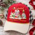 Small Town Christmas DTF Transfer | Hand-Painted Snowy Village Design, festive transfer displayed on a red and white trucker cap featuring a hand-painted snowy village, Santa and reindeer, and gold lettering
