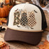 Boo Halloween DTF transfer with camo block letter B and two bow-topped ghost letters in polka-dot and checkerboard patterns, surrounded by bats and spiderwebs Shown on a cream front panel, chocolate brown bill, black mesh back, tan rope trucker hat.