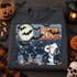 Halloween DTF transfer featuring a cartoon beagle holding a BOO! sign in a starry graveyard scene with a full moon, bats, tombstones, skulls, bones, and pumpkins Shown on a Graphite Heather crewneck sweatshirt.