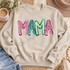 Playful graffiti-style MAMA DTF transfer in alternating pink, teal, and green hand-lettered letters with black outlines and white highlights Shown on a Sand crewneck sweatshirt.