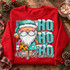Watercolor Santa gnome DTF transfer with leopard and teal patchwork coat, snow-capped HO HO HO lettering, and Merry Christmas script on plaid background Shown on a Cherry Red crewneck sweatshirt.