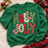 Holly Jolly Christmas DTF transfer in bold bubble letters with mixed leopard print, checkerboard, candy stripe, polka dot, and Christmas tree patterns Shown on a Irish Green crewneck sweatshirt.