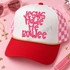 Jesus Made Me Boujee DTF transfer in chunky pink bubble lettering with red outlines and glossy white highlights on a light blue shirt Shown on a white front panel with red bill and pink-and-white checkered mesh back trucker hat.