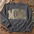 MIMI block-letter DTF transfer with checkerboard, camo, leopard, and polka dot patterns, white outlines, and cream bow accents Shown on a Graphite Heather crewneck sweatshirt.