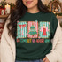 Oh Come Let Us Adore Him Christmas DTF transfer with scalloped holiday-striped frames featuring a red bow, decorated tree, and angel, above bold multicolor lettering Shown on a Forest crewneck sweatshirt.