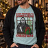 Hooded horror movie killer holding a knife and wrapped Christmas present on a snowy windowsill DTF transfer, with distressed red lettering reading Have Yourself a Scary Little Christmas Shown on a Island Reef t-shirt.