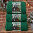 Have Yourself a Scary Little Christmas DTF transfer with Ghostface-style killer holding a knife and wrapped present at a snowy window with Christmas tree Shown on a Irish Green crewneck sweatshirt.