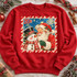 Vintage-style Christmas postage stamp DTF transfer featuring Santa Claus nuzzling noses with a plaid-scarved snowman under a starry night sky, framed by a candy-cane striped stamp border Shown on a Cardinal Red crewneck sweatshirt.