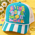 Better Days Are On The Way DTF transfer with colorful paper-collage lettering, a smiley face, stars and flowers Shown on a Teal front panel with white rope and white mesh back trucker hat.