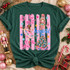 It's The Most Wonderful Time of the Year Christmas DTF transfer with pink ballerina, nutcracker soldier, decorated tree and pink polka-dot stripes Shown on a Emerald t-shirt.