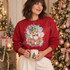 Whimsical pink and teal nutcracker head DTF transfer with gold jeweled details, pearl trim, florals, hearts, and watercolor splatters Shown on a Cherry Red crewneck sweatshirt.