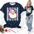 Vintage-style Santa Claus face DTF transfer with pink hat and holly, framed in a scalloped pink and teal oval border with snowflakes and stars Shown on a Navy t-shirt.