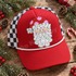 Whimsical Santa face DTF transfer with red polka-dot hat, curly white hair and beard, and pink cheeks in hand-drawn line art style Shown on a cardinal red front panel, white rope, black-and-white checkered mesh back trucker hat.