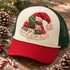 Quilted patchwork Santa hat DTF transfer with red and green holiday-print fabric squares, crosshatch stitching, crocheted lace trim, and a chunky pom-pom tassel Shown on a Cream front panel / crimson red bill / forest green mesh trucker hat.