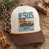 Jesus the reason for the season DTF transfer with bold vintage JESUS lettering and illustrated manger with baby Jesus in golden straw Shown on a oatmeal front panel with brown bill, mustard gold rope, and leopard mesh back trucker hat.