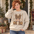 Leopard-print nutcracker head DTF transfer with golden crown, feather plume, and curled white beard, set against painted stripe backdrop Shown on a Sand crewneck sweatshirt.