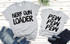 Nerf Gun Loader Screen Print Heat Transfer, gray T-shirts with bold black text design, laid on a white wooden surface with denim jeans.
