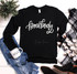 Homebody ADULT Screen Print Transfer, black sweatshirt with white script text reading 'homebody', styled with jeans, a mug, a blanket, and boots around it.