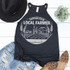 Support Your Local Farmer White Screen Print Transfer, a black sleeveless top with white farm scene design and text, paired with distressed denim shorts, a black hat, leopard print shoes, and a small green plant, flat lay arrangement.