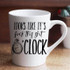 Looks like it's fuck this shit O'clock sublimation transfer on a white ceramic mug, with a clock illustration and bold black text.
