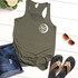Beer Babe HAT/POCKET/CAN HUGGER Screen Print Heat Transfer, khaki tank top with 'Beer Babe' design on the front, paired with denim shorts, sunglasses, and sandals, on white wooden background.