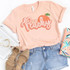 Just Peachy ADULT Screen Print Heat Transfer, peach illustration with the text "Just Peachy" on a light pink T-shirt.