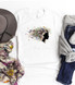 Wildflowers Soul Sublimation Transfer, product image showing a t-shirt with a floral silhouette of a woman with colorful wildflowers and butterflies, surrounded by accessories like a hat, scarf, and denim jeans.