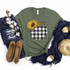 Plaid Pumpkin Screen Print Transfer, green t-shirt with sunflower and pumpkin design on it, surrounded by denim jeans, beige woven shoes, navy blue scarf, and decorative pumpkins for fall or Halloween celebration.