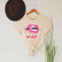 Wet Lips Screen FINAL STOCK Print Heat Transfer, beige T-shirt with a graphic of glossy pink lips and the words 'WAP' in bold pink letters.