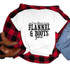 Ain't No Shame In My Flannel And Boots Game Sublimation Transfer, white T-shirt with black text displayed on a flat lay with red and black plaid shirt, blue jeans, and brown boots.