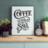 Coffee Warms The Soul Sublimation Transfer, decorative wall art with calligraphic text, displayed on a kitchen wall with flowers, clock, and potted plant.